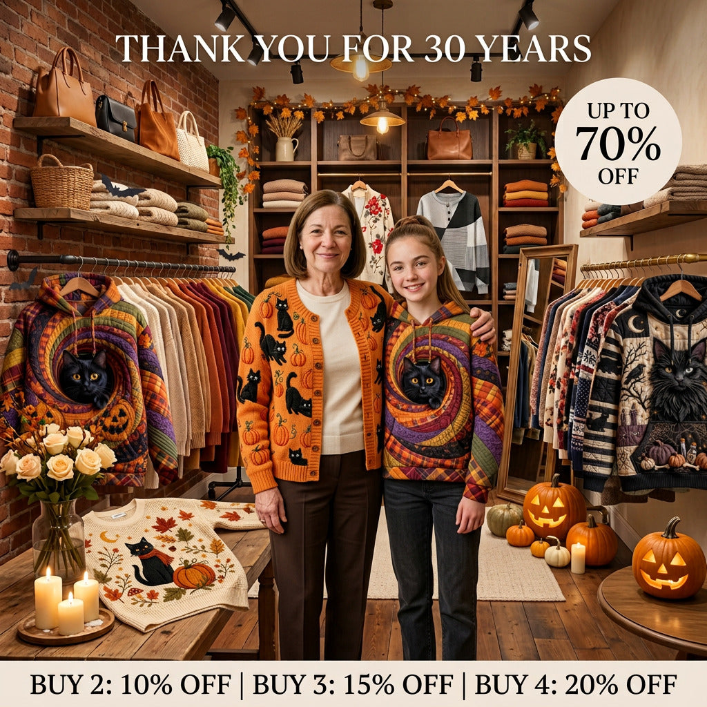 Halloween Edit banner: two women wearing black-cat and pumpkin print cardigans in a boutique decorated for Halloween